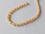faceted glass beads - 5mm x 3mm - teardrop - pale orange 