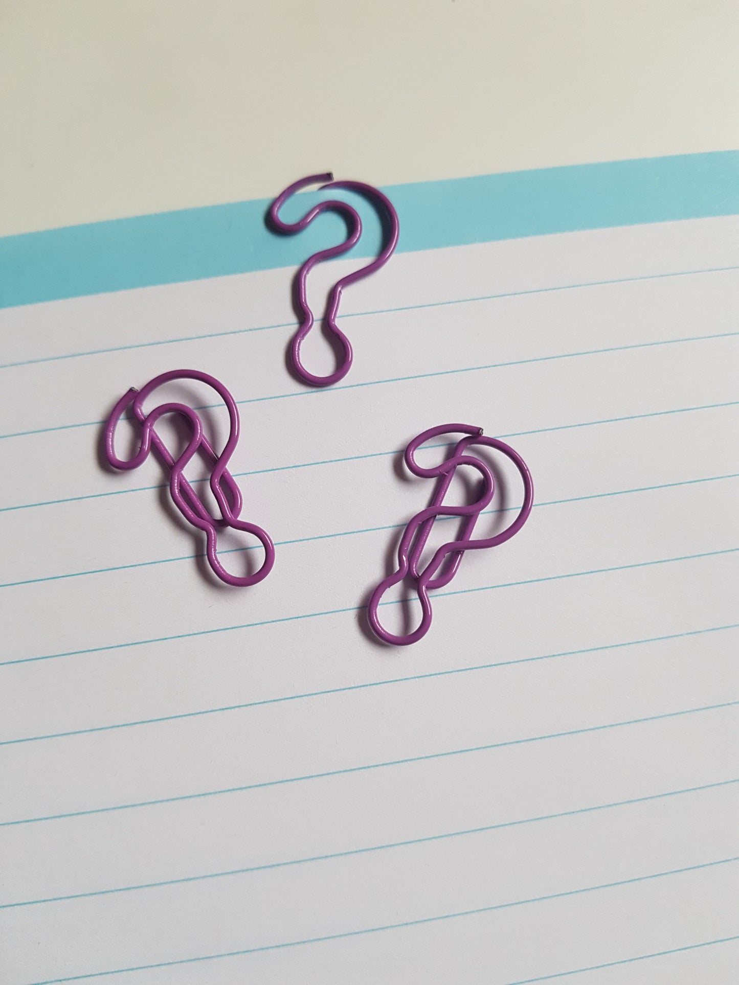 purple question mark paper clips