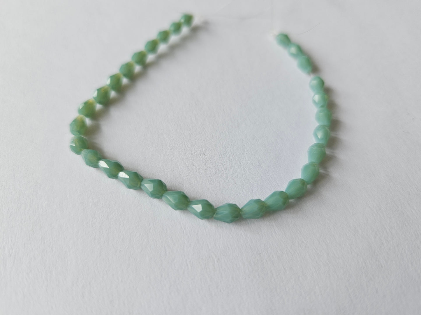 faceted glass beads - 5mm x 3mm - teardrop - pale green 