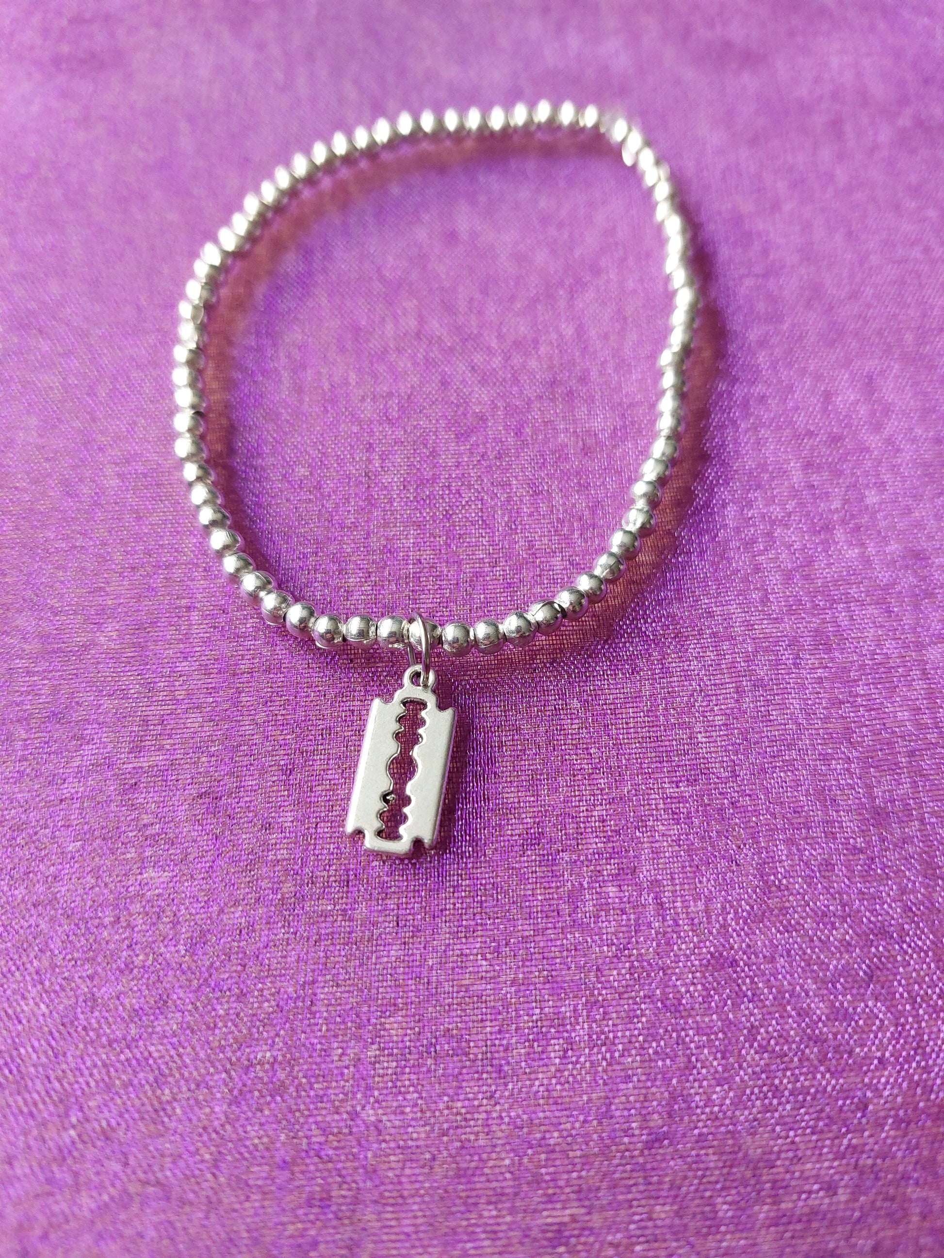 beaded razorblade charm bracelet