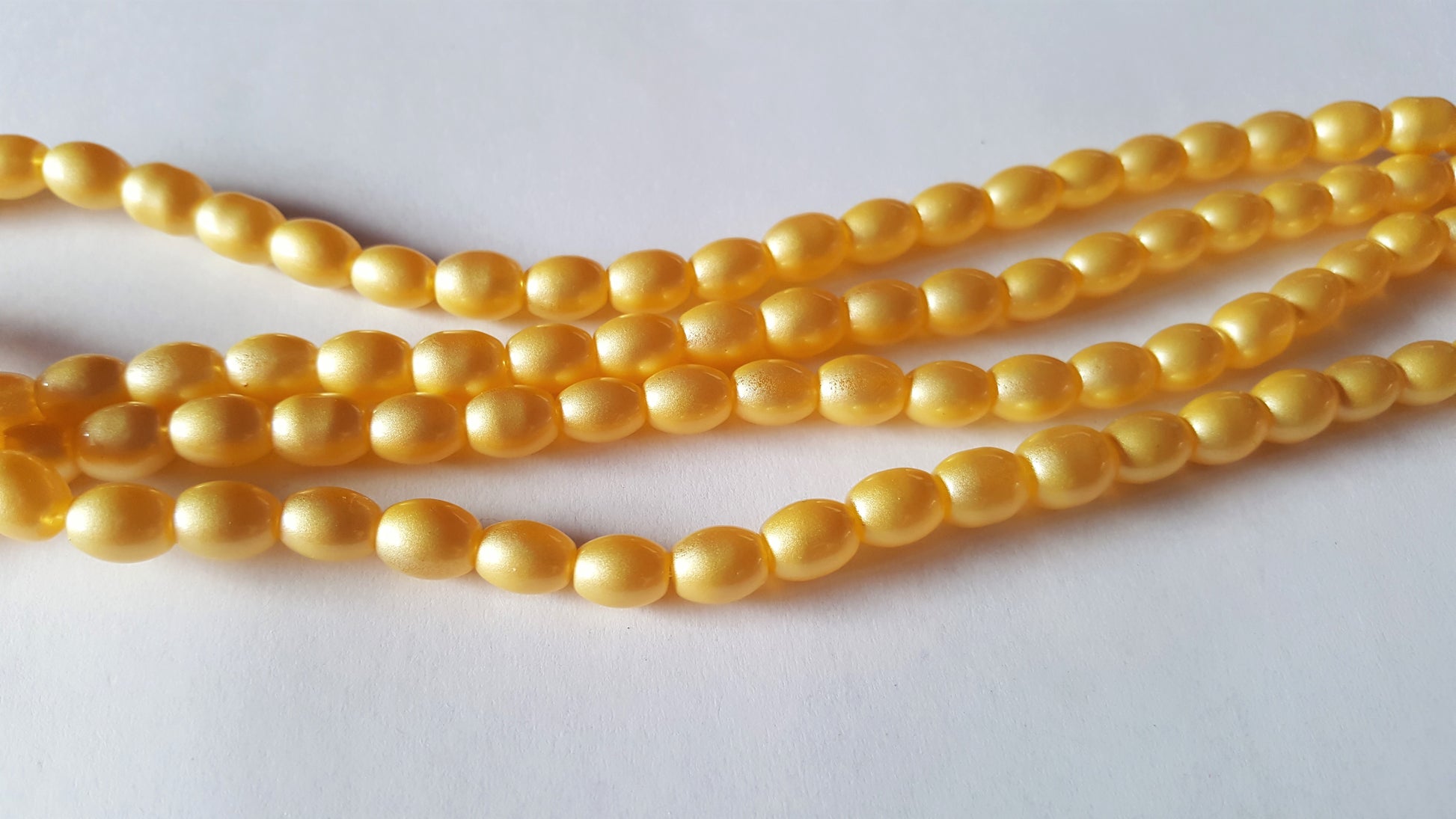 sprayed glass oval beads - pastels - yellow