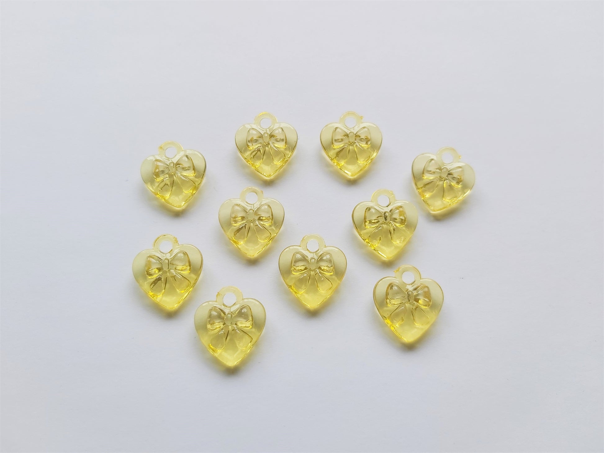 17mm acrylic heart pendants - bow design - yellow